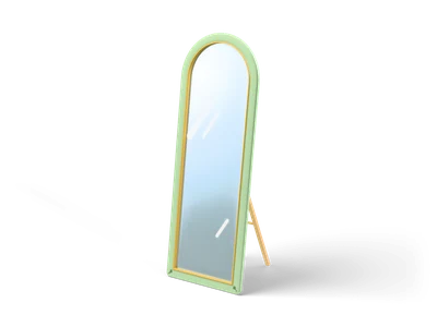 Tall arched floor mirror with a sage green frame and gold trim leaning on a wooden stand