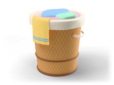 Round wicker laundry basket with a cream liner, rope handles, pastel laundry and a yellow towel over the edge