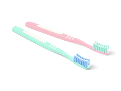 Two pastel toothbrushes in mint and pink lying side by side with white and blue bristle tufts